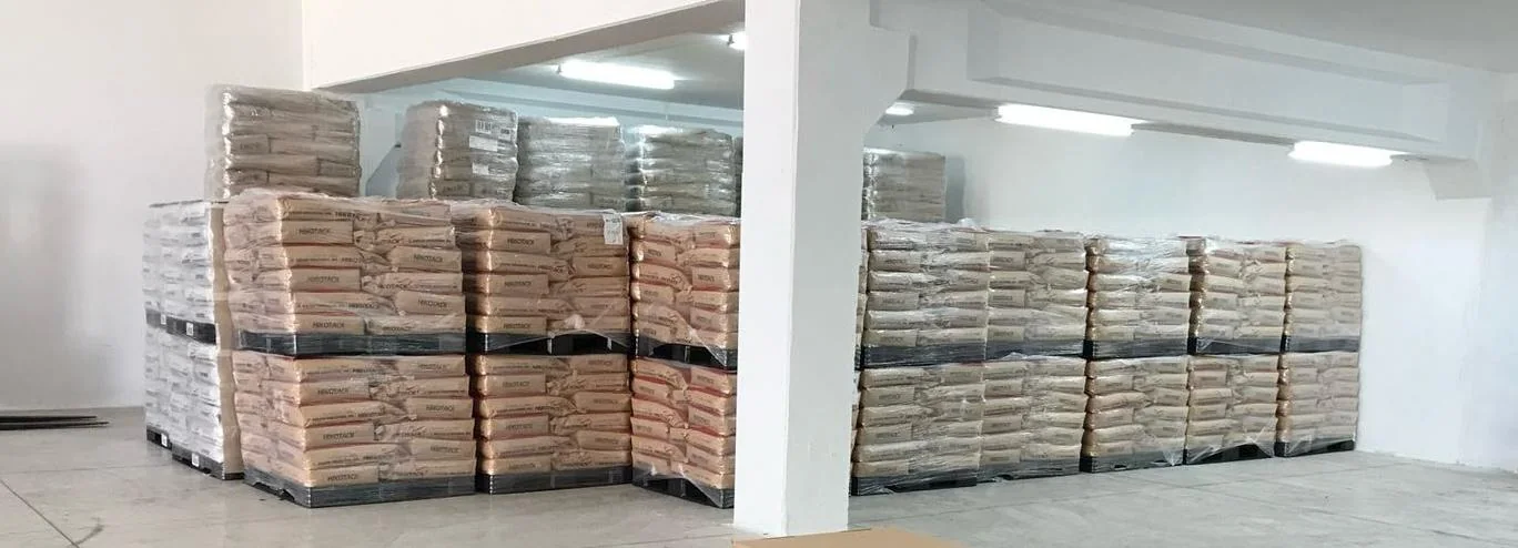 Palletised bags of adhesive materials stored in a warehouse